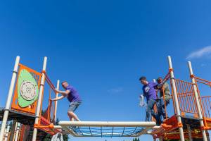 Travis Hammond, left, and Chris McGravey navigate their way across a play structure on Wednesday, Aug. 20, 2025 in Marysville, Washington. (Olivia Vanni / The Herald)