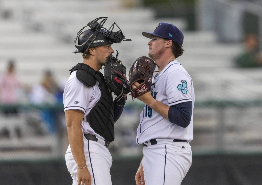 Everett AquaSox pitcher Ryan Hawks talks with Everett AquaSox catcher Josh Caron during the game against the Spokane Indians on Tuesday, Aug. 19, 2025 in Everett, Washington. (Olivia Vanni / The Herald)