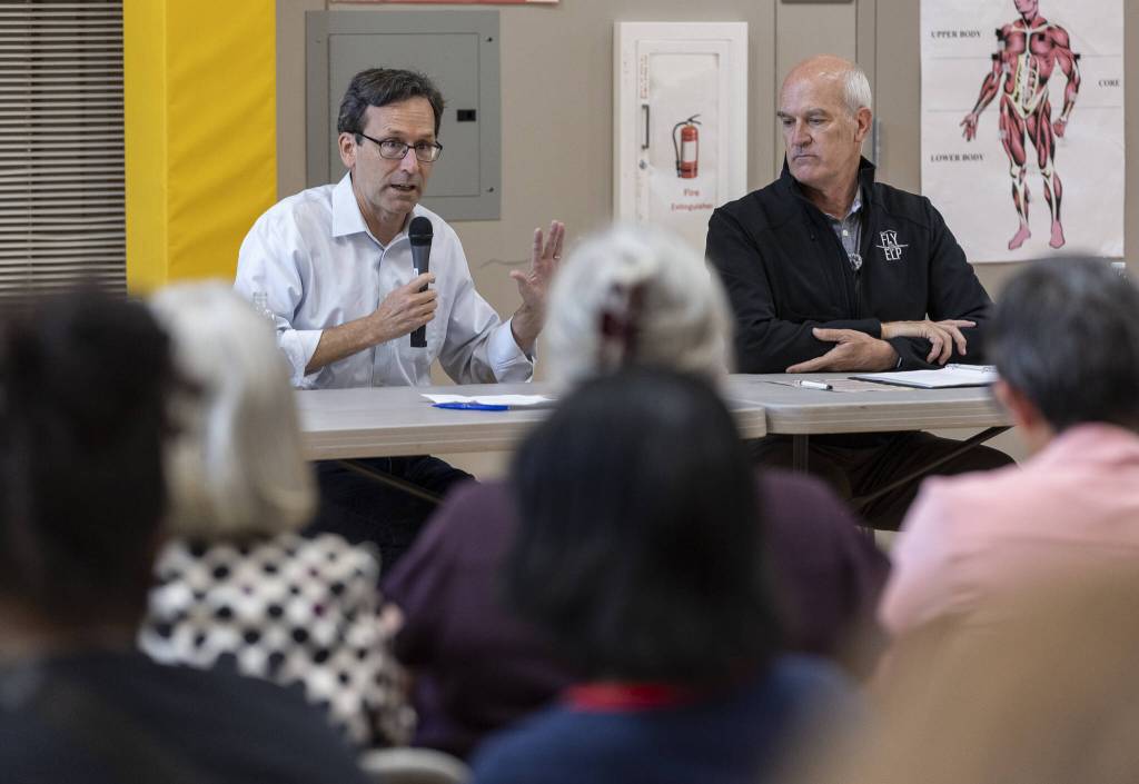 Gov. Bob Ferguson and Rep. Rick Larsen, D-Everett, talk during a listening session with with community leaders and families addressing the recent spending bill U.S. Congress enacted that cut Supplemental Nutrition Assistance Program funding by 20% on Thursday, Aug. 21, 2025 in Lynnwood, Washington. (Olivia Vanni / The Herald)