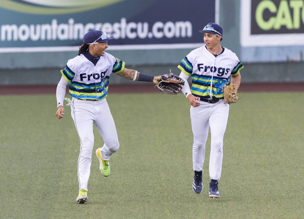 Everett AquaSox outfielder Tai Peete and Everett AquaSox outfielder Jonny Farmelo talk as they run in from the outfield between innings during the game against the Spokane Indians on Wednesday, Aug. 20, 2025 in Everett, Washington. (Olivia Vanni / The Herald)
