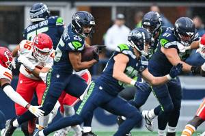 Seahawks' running back Zach Charbonnet (26) runs with the ball against the Kansas City Chiefs as Seattle receiver Cooper Kupp (10) looks to block in a preseason game on Friday, Aug. 15, 2025 at Lumen Field in Seattle, Washington. (Photo courtesy of the Seattle Seahawks)