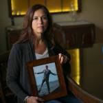 Cathi Lee holds a photo of her son, Corey, at the Lee family home Wednesday, August 30, 2023, in Everett, Washington. Lee has been involved in organizing local events for Overdose Awareness Day in the years since Corey’s death in 2015. (Ryan Berry / The Herald)