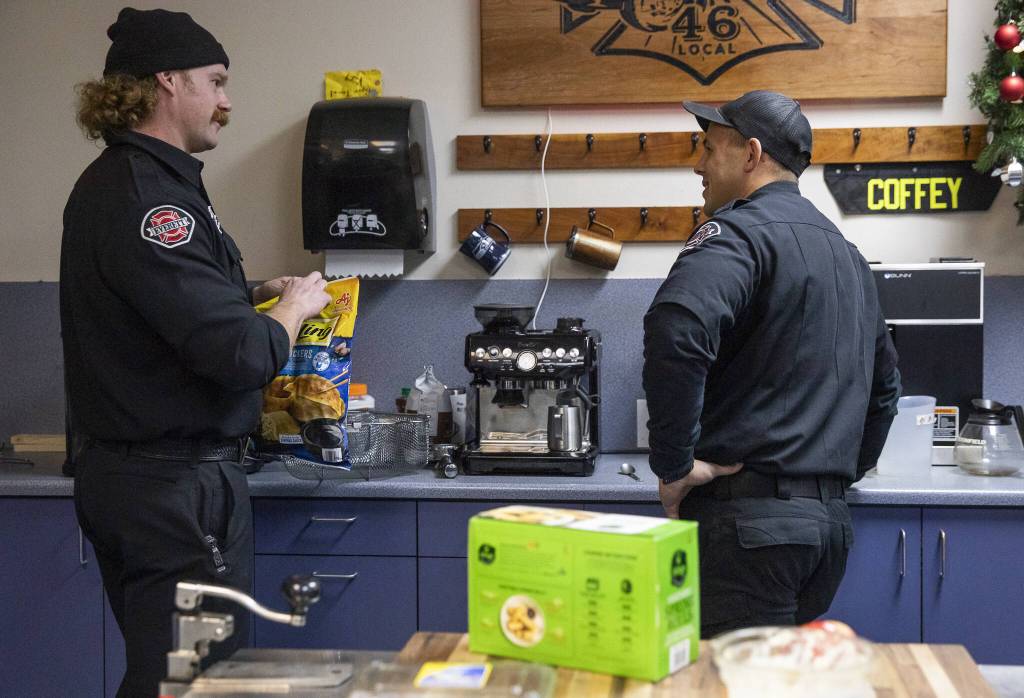 Ryan Fromm and Mike Aquino chat in the kitchen of Fire Station One on Tuesday, Dec. 10, 2024 in Everett, Washington. (Olivia Vanni / The Herald)
Firefighters Ryan Fromm and Mike Aquino chat in the kitchen of Everett Fire Station One. (Olivia Vanni / The Herald)
