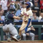 Phillies shortstop Trea Turner scores past Seattle Mariners catcher Cal Raleigh on a two-run single by Kyle Schwarber on Wednesday. The Phillies swept the Mariners at Citizens Bank Park this week. (Jose F. Moreno / Tribune News Services)