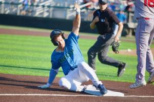 AquaSox infielder Charlie Pagliarini slides into third base after hitting a triple in Everett's 5-1 loss to the Spokane Indians at Funko Field on Aug. 24, 2025. (Joe Pohoryles / The Herald)