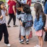 Damian Flores, 6, kisses his mother Jessica Flores goodbye before heading inside for his first day of first grade at Monroe Elementary School on Wednesday, Aug. 27, 2025 in Everett, Washington. (Olivia Vanni / The Herald)