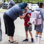 Rachel Miles kisses her son Axel Miles, 7, goodbye before he heads inside for his first day of school at Monroe Elementary School on Wednesday, Aug. 27, 2025 in Everett, Washington. (Olivia Vanni / The Herald)