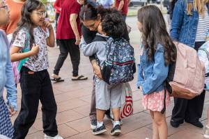 Damian Flores, 6, kisses his mother Jessica Flores goodbye before heading inside for his first day of first grade at Monroe Elementary School on Wednesday, Aug. 27, 2025 in Everett, Washington. (Olivia Vanni / The Herald)
