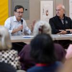 Gov. Bob Ferguson and Rep. Rick Larsen talk during a listening session with with community leaders and families addressing the recent spending bill U.S. Congress enacted that cut Supplemental Nutrition Assistance Program funding by 20% on Thursday, Aug. 21, 2025 in Lynnwood, Washington. (Olivia Vanni / The Herald)