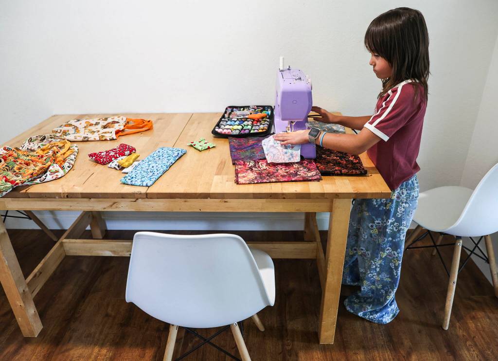 Eisley Lewis, 9, at the table at her home where she worked to create the majority of her inventory to sell on Wednesday, Aug. 27, 2025 in Everett, Washington. (Olivia Vanni / The Herald)