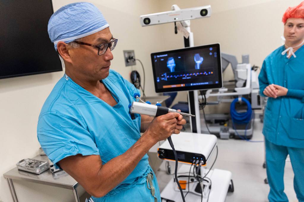 Dr. Bill Huang, an orthopedic surgeon, talks about how the system tracks his tools movements on Wednesday, Sept. 3, 2025 in Everett, Washington. (Olivia Vanni / The Herald)