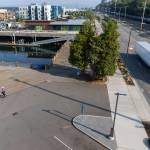 A semi truck and a unicycler move along two sections of Marine View Drive and Port Gardner Landing that will be closed due to bulkhead construction on Wednesday, Sept. 3, 2025 in Everett, Washington. (Olivia Vanni / The Herald)
