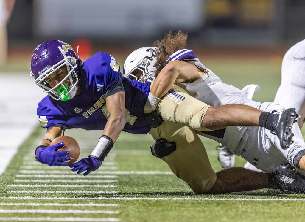 Lake Stevens Seth Price is tackled to the ground after getting a first down during the game against Sumner on Friday, Sept. 5, 2025 in Lake Stevens, Washington. (Olivia Vanni / The Herald)