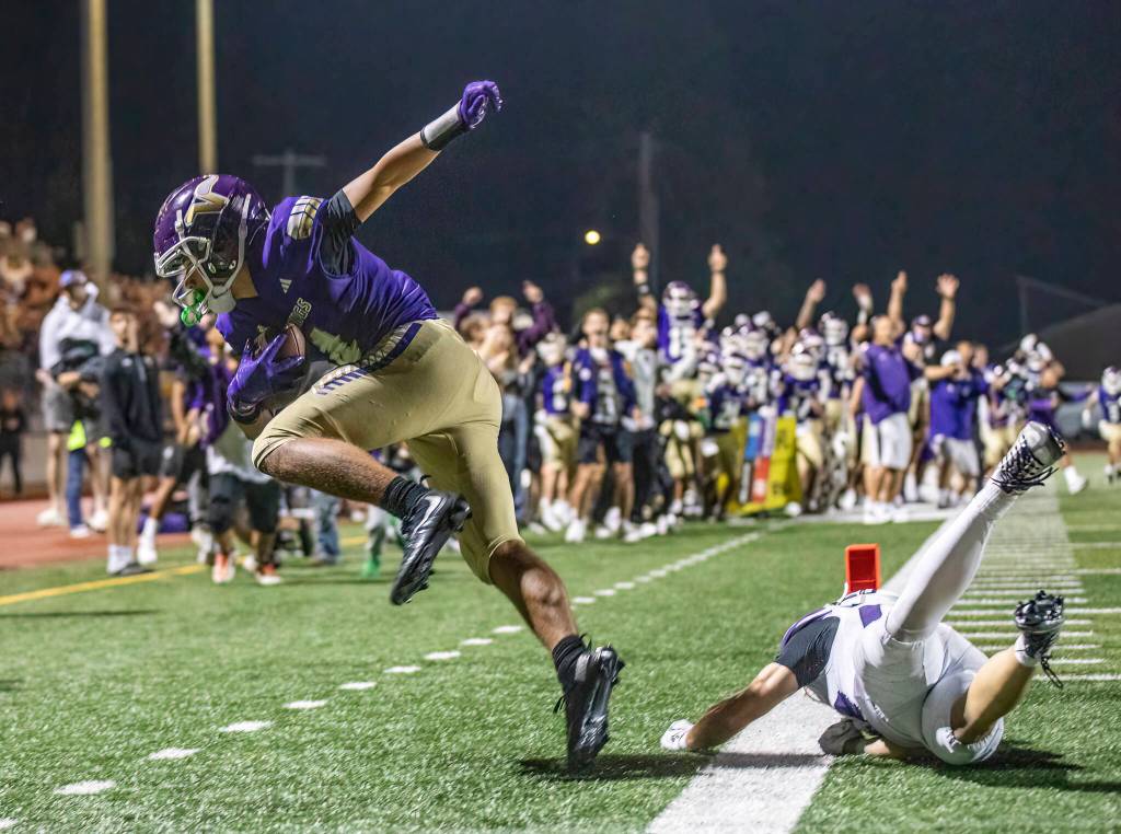 Lake Stevens Seth Price jumps out of bound after making the game winning touchdown catch in the final seconds of the game against Sumner on Friday, Sept. 5, 2025 in Lake Stevens, Washington. (Olivia Vanni / The Herald)