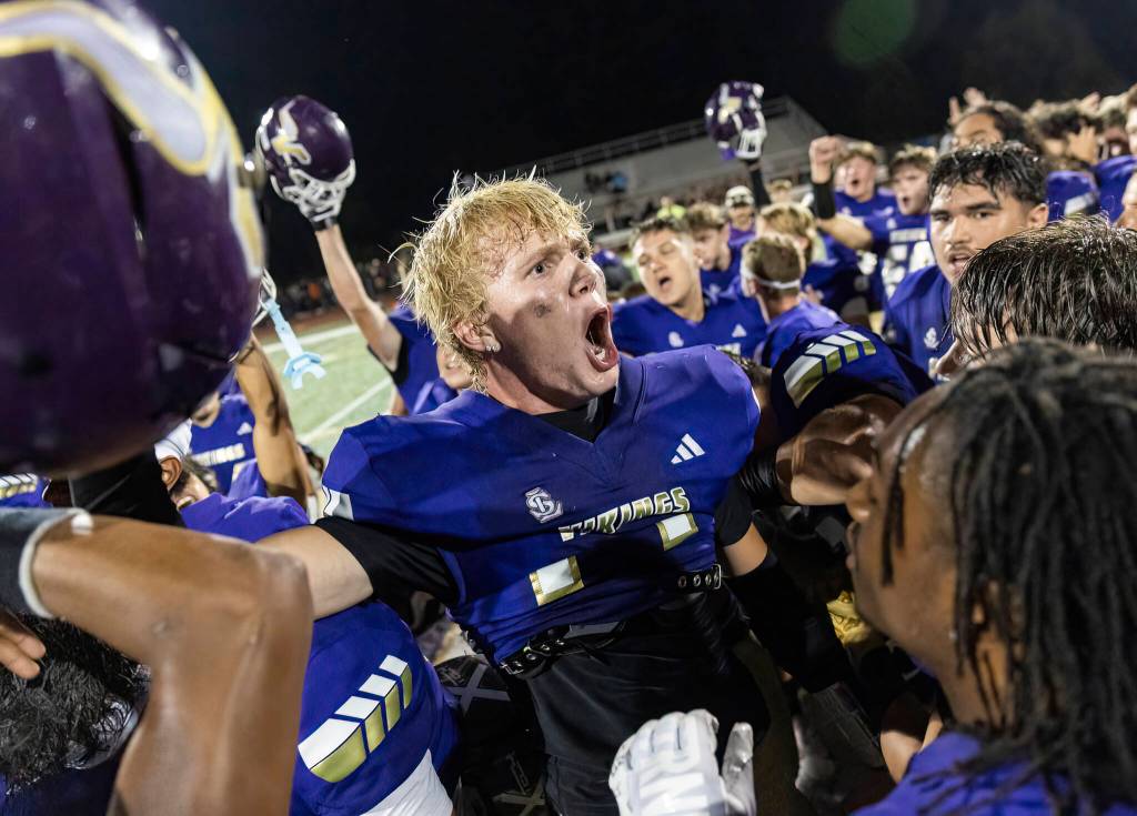 Lake Stevens Dylan Phinney yells with his teammates after beating Sumner on Friday, Sept. 5, 2025 in Lake Stevens, Washington. (Olivia Vanni / The Herald)