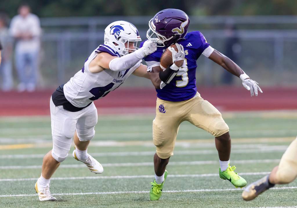 Lake Stevens Jayvian Ferrell-Gilkey has his face mask pulled while running the ball during the game against Sumner on Friday, Sept. 5, 2025 in Lake Stevens, Washington. (Olivia Vanni / The Herald)
