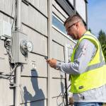 Snohomish PUD Meter Deployment Technician Austin Waters checks an old meter prior to a recent installation. (Krysta Rasmussen/Snohomish PUD)