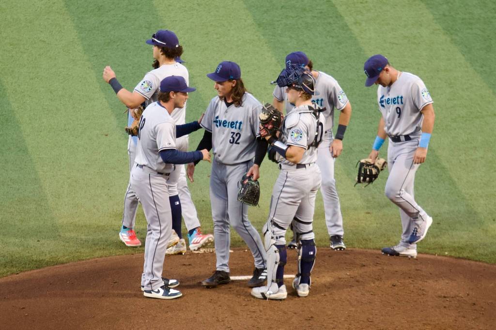 AquaSox manager Zach Vincej (left) shakes hands with pitcher Teddy McGraw (center) as he removes him from Everetts 4-2 loss to the Eugene Emeralds in Game 2 of the 2025 Northwest League Championship Series at PK Park on Wednesday. (Joe Pohoryles / The Herald)