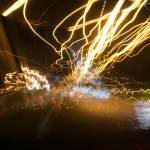 Street lights in speeding car in night time, light motion with slow speed shutter.Street lights in speeding car in night time, light motion with slow speed shutter view from inside front of car. Getty Images