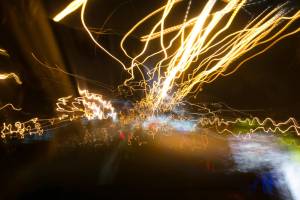 Street lights in speeding car in night time, light motion with slow speed shutter.Street lights in speeding car in night time, light motion with slow speed shutter view from inside front of car. Getty Images