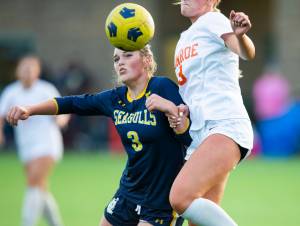 Everett’s Avery Hammer arm is grabbed by Monroe’s Katelyn Paxton while they jump to get a loose ball during the game on Thursday, Sept. 7, 2023 in Everett, Washington. (Olivia Vanni / The Herald)