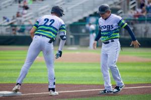 AquaSox manager Zach Vincej (right) celebrates with outfielder Jonny Farmelo after he reaches third base safely against the Eugene Emeralds in Game 3 of the 2025 Northwest League Championship Series at Funko Field on Sept. 12, 2025. (Joe Pohoryles / The Herald)