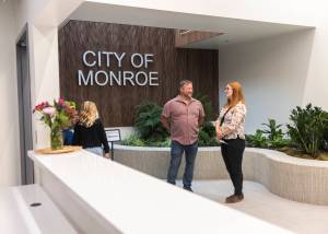 People gather in the lobby of the new City of Monroe building on Monday, July 14, 2025 in Monroe, Washington. (Olivia Vanni / The Herald)
