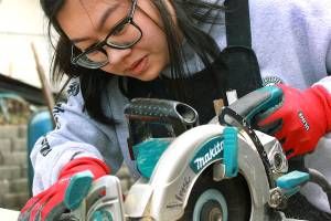 Stephanie Lam, with AmeriCorps, does framing at the Twin Creeks Village construction site. (Habitat for Humanity of Snohomish County)