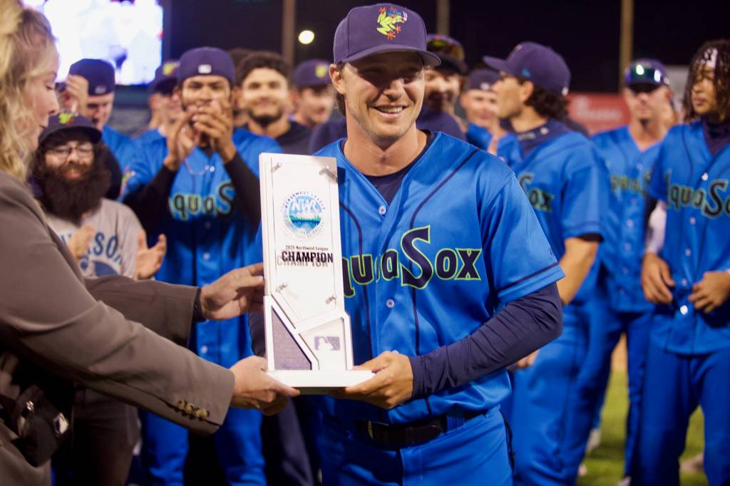 AquaSox manager Zach Vincej is presented the Northwest League Championship trophy following Everetts series-clinching 6-3 win in Game 4 against the Eugene Emeralds at Funko Field on Sept. 13, 2025. (Joe Pohoryles / The Herald)
