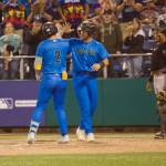 AquaSox catcher Matthew Ellis (right) greets third baseman Luis Suisbel at home plate following the latters go-ahead, two-run home run to help Everett beat the Eugene Emeralds 6-3 in Game 4 to clinch the 2025 Northwest League Championship at Funko Field on Sept. 13, 2025. (Joe Pohoryles / The Herald)