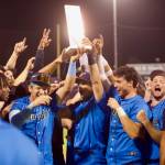 AquaSox infielders Luis Suisbel (center, left) and Charlie Pagliarini (center, right) hoist the Northwest League Championship trophy as teammates celebrate around them following Everetts series-clinching 6-3 win in Game 4 against the Eugene Emeralds at Funko Field on Sept. 13, 2025. (Joe Pohoryles / The Herald)