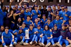 The Everett AquaSox pose in front of the outfield scoreboard with the championship trophy after beating the Eugene Emeralds 6-3 in Game 4 to clinch the 2025 Northwest League Championship at Funko Field on Sept. 13, 2025. (Joe Pohoryles / The Herald)