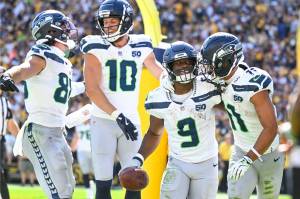 Seahawks running back Kenneth Walker III (9) celebrates with teammates AJ Barner (88), Cooper Kupp (10) and Jaxson Smith-Njigba after scoring a touchdown in Seattle's 31-17 win over the Pittsburgh Steelers on Sunday, Sept. 14, 2025 at Acrisure Stadium in Pittsburgh, Pennsylvania. (Photo courtesy of the Seattle Seahawks)