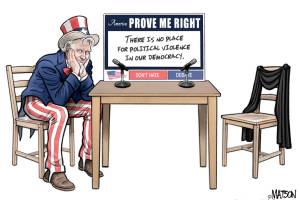 young handsome man in grey sweater sitting on chair isolated on white