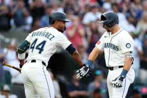 Cal Raleigh (29) celebrates with Mariners teammate Julio Rodríguez (44) after his 50th homer during the 2025 season. (Steph Chambers / Getting Images / The Athletic)