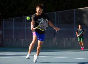 Jackons Samuel Song hits the ball during a doubles match against Kamiak on Monday, Sept. 30, 2024 in Mill Creek. (Olivia Vanni / The Herald)