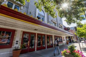 A person walks past the freshly painted exterior of the Everett Historic Theatre on Sept. 24, 2025 in Everett, Washington. (Olivia Vanni / The Herald)