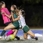 Edmonds-Woodways Madalyn Bryant collides with Shorecrests Sydney Beer and Shorecrests Mickie McNeil in the goal box during the game on Sept. 23, 2025 in Shoreline, Washington. (Olivia Vanni / The Herald)