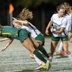 Shorecrests Olivia Taylor and Edmonds-Woodways Liliana Frank fall as Edmonds-Woodways Alison Schell knocks the ball away during the game on Sept. 23, 2025 in Shoreline, Washington. (Olivia Vanni / The Herald)