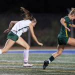 Shorecrests Pip Watkinson beats Edmonds-Woodways Liliana Frank as she dribbles toward the goal during the game on Sept. 23, 2025 in Shoreline, Washington. (Olivia Vanni / The Herald)