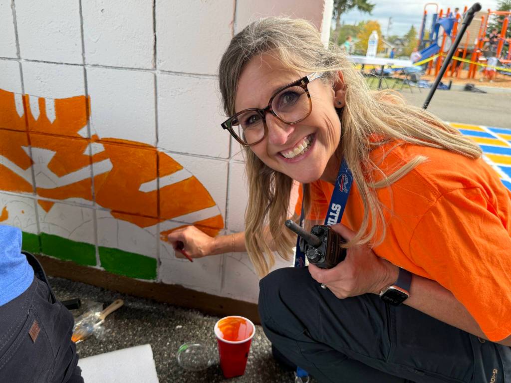 One of more than 90 volunteers who helped paint graphics and murals at Garfield Elementary School on Sept. 12 in Everett.