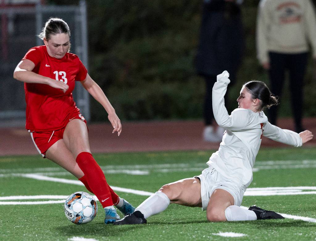 Snohomishs Jo Cort slides to knock the ball away from Stanwoods Maggie Martin during the game on Sept. 25, 2025 in Stanwood, Washington. (Olivia Vanni / The Herald)