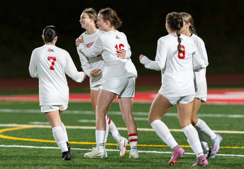 Snohomishs Nevaeh Howerton hugs her teammates after scoring during the game against Stanwood on Sept. 25, 2025 in Stanwood, Washington. (Olivia Vanni / The Herald)