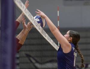 Lake Stevens’ Olivia Gonzales blocks a tipped ball from coming over the net during the 4A district semifinal game on Thursday, Nov. 14, 2024 in Lynnwood, Washington. (Olivia Vanni / The Herald)