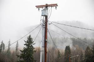 A different utility lines branch off in different directions from a utility pole along Railroad Avenue in 2024 in Skykomish. A bill proposed this year looked to add civil penalties for scrapyards that make deals for stolen copper used in telecommunication cables, but it failed to gain traction in the Legislature despite bipartisan support. (Olivia Vanni / The Herald)