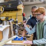 Adam Allen, 12, drills a hole in the neck of his canjo with the help of teacher Alex Moll during class on Oct. 7, 2025 in Lake Stevens, Washington. (Olivia Vanni / The Herald)