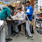 Ajitesh Singh, 12, left, David Poinaru, 12, center, and Vihaan Gaddam, 12, sand the necks of their canjos during class on Oct. 7, 2025, in Lake Stevens, Washington. (Olivia Vanni / The Herald)