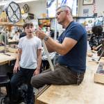 Teacher Alex Moll helps Noah Clemens, 12, with his canjo during class on Oct. 7, 2025, in Lake Stevens, Washington. (Olivia Vanni / The Herald)