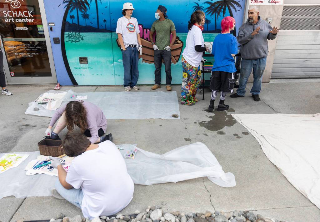 Graffiti artist AYE147 talks about different techniques for spray painting during Teen Night at the Schack Art Center on Sept. 18, 2025 in Everett, Washington. (Olivia Vanni / The Herald)