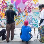 A handful of teens work on a collaborative graffiti project during Teen Night at the Schack Art Center on Sept. 18, 2025 in Everett, Washington. (Olivia Vanni / The Herald)